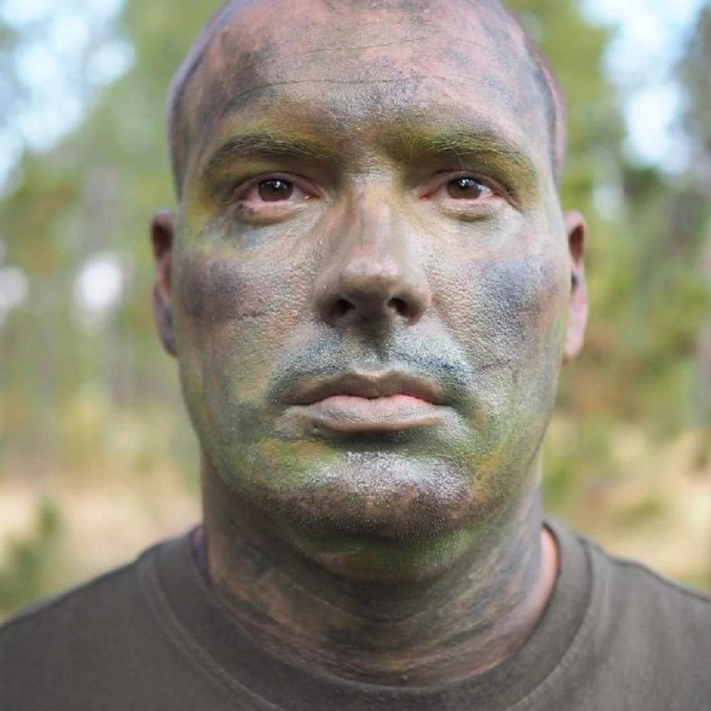 face paint for camoflague on man's face outdoors