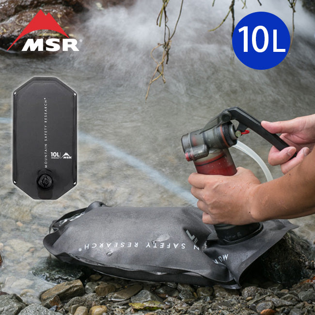 A person using the MSR Guardian Water Purifying system to fill a Rugged water storage bag with creek water.