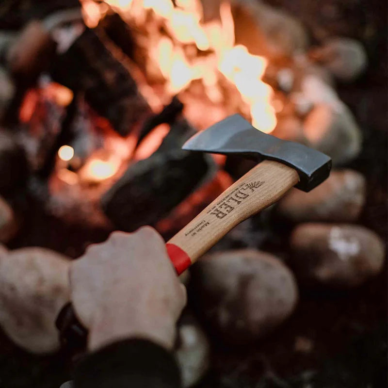 Adler Premium Rheinland Hatchet with Sheath outdoors being held over a campfire