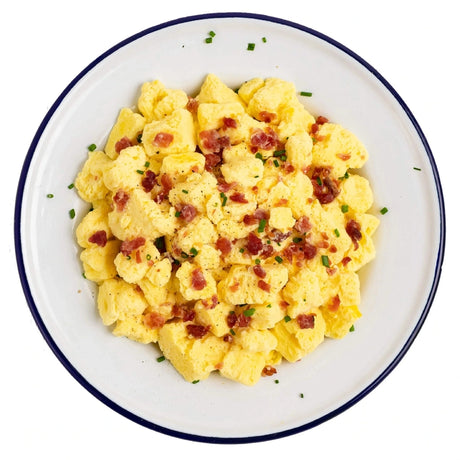 Mountain House Freeze Dried Scrabbled eggs and bacon prepared in a dish. 