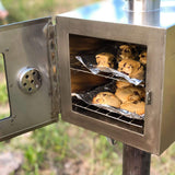 Winnerwell Pipe Oven in use outdoors baking cookies
