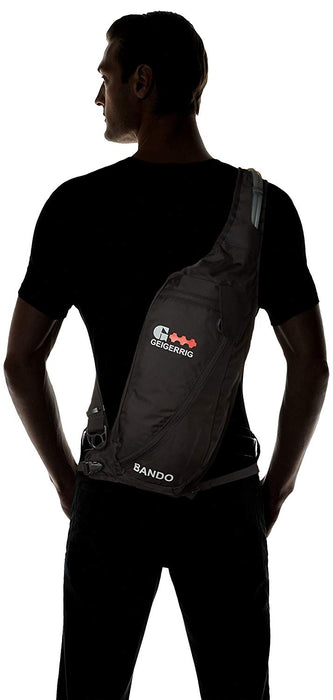 Man wearing the Geigerrig Rig Bando Hydration Pack in Black with red details around his shoulder and buckeled in at the waist.
