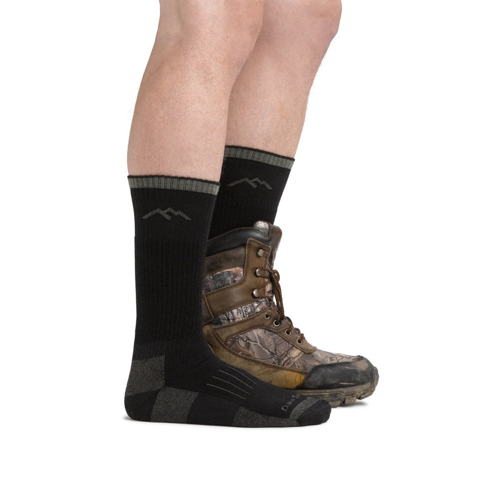 Man Wearing Charcoal Hunting Boot Sock Midweight with Cushion + Cushion in leg with one boot one

