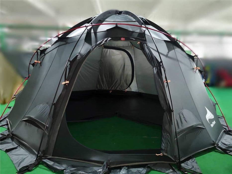 The completed construction of the NorTent Gamme 4 person tent in black with red tent poles. The entry was is open exposing the spacious inner tent on green astro turf.