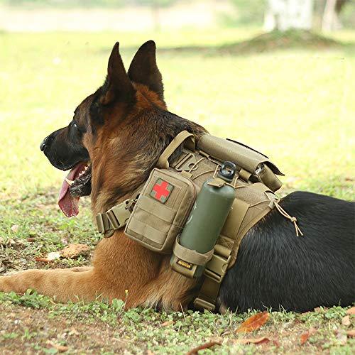A german shepherd taking a break laying ont he ground with the Mill-Spex k-9 Tactical Molle Dog vest on. A first aid kit is attached to the vest with a green water bottle. The dog is laying on grass in a park during the day.
