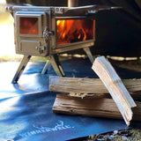 Fireproof mat in use under a Winnerwell stove inside a tent.