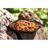 Freeze Dried Vegetarian Chili from Happy Yak Express. The green camping bowl is is laid on a tree log.