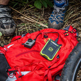 The venture 30 power bank on mountain bikers red backpack charging up a gopro camera.