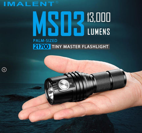 Imalet ms03 flashlight fitting in the palm of a persons hand over a ocean shore landscape.