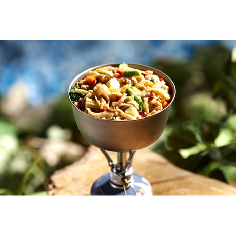 A camp stove being used to boil and cook a Freeze dried package of Happy Yak's Pad Thai.