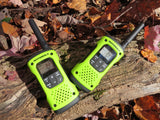 Two lime green and black Talkabout T600 Radios on a tree log in the fall. Leaves populate the surrounding area.